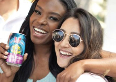 Two Women Smiling and drinking Golden Monkey Beer